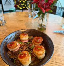 River signature dishes Black Warrior Burger, Seared Scallops, Pork Belly, Pimento Cheese